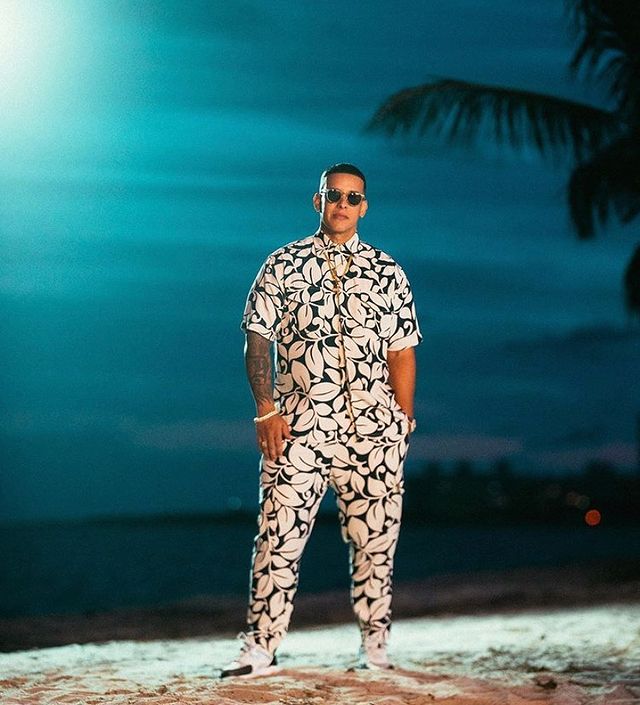 daddy yankee wearing white leaves with blue color in tee and joggers.